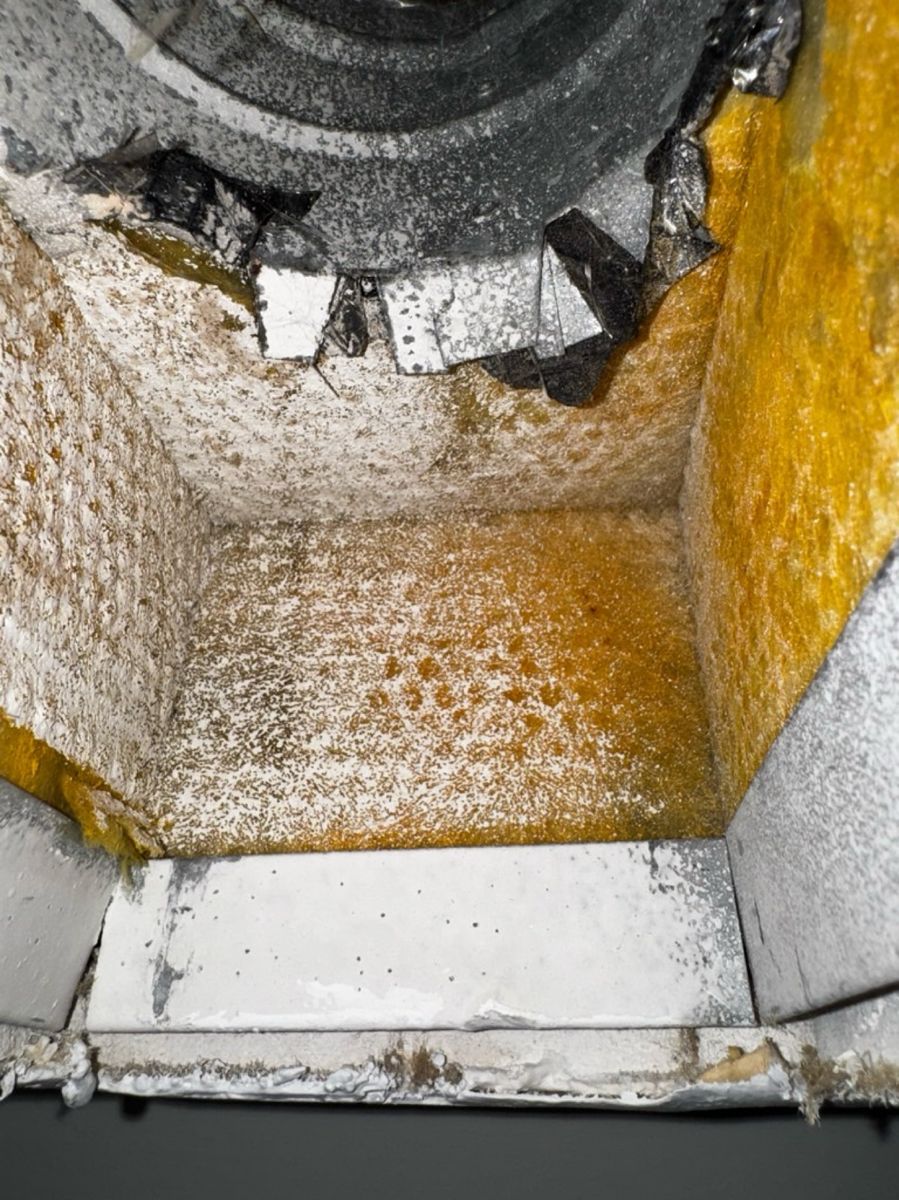 Heavy brown and orange buildup inside a South Florida home's duct before service