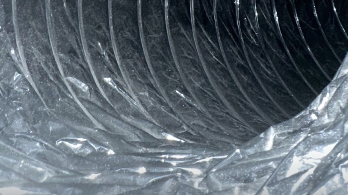 Same dark flexible air duct cleared after professional cleaning